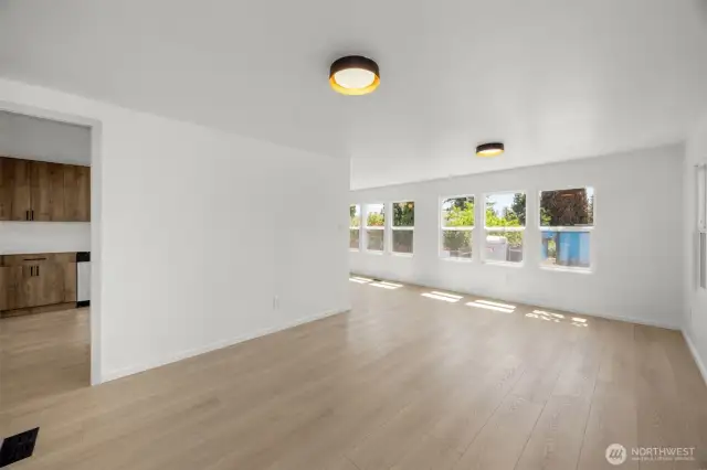 Enter the home into this spacious, light-filled living area