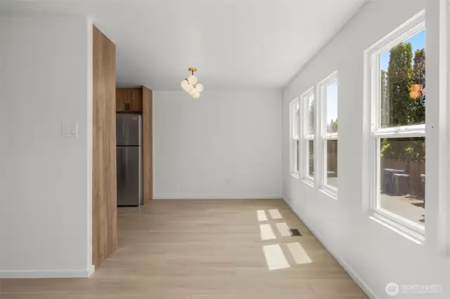 Dining area (around the corner from living area) with kitchen to the left