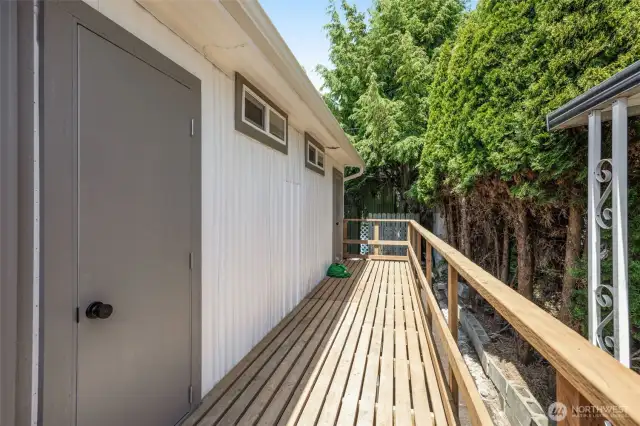Back deck with doors leading to 3rd bedroom and kitchen