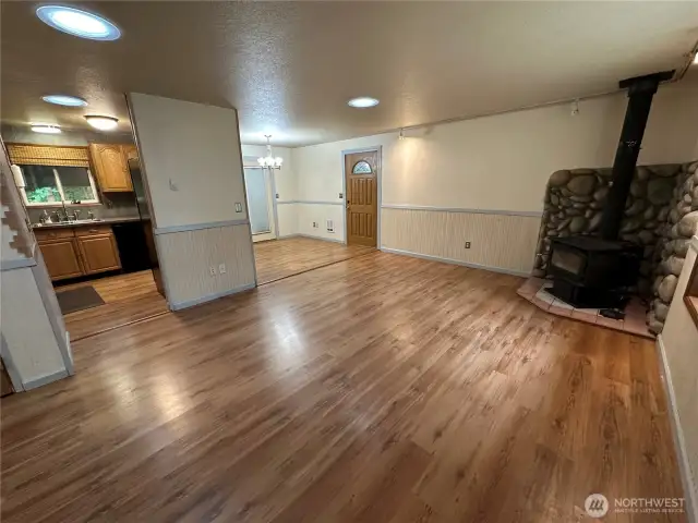 Enter into the open concept livng room, dining area and kitchen with access to the back patio and side yard
