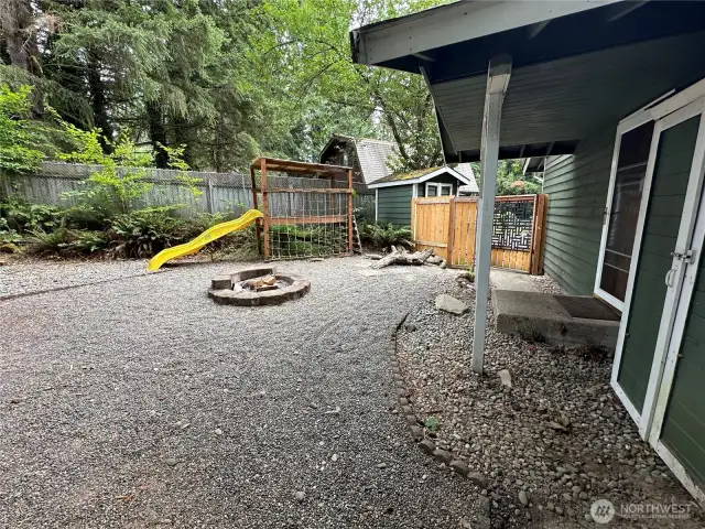 Side yard with firepit and play area