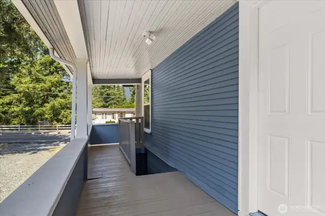 Covered back porch with stairs down to the unfinished basement.