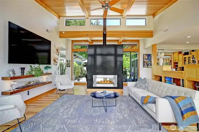 Living room looking toward the entry. Steel double sided gas fireplace....