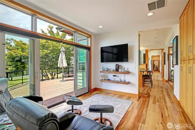 Family room with large TV and floating Shelves.