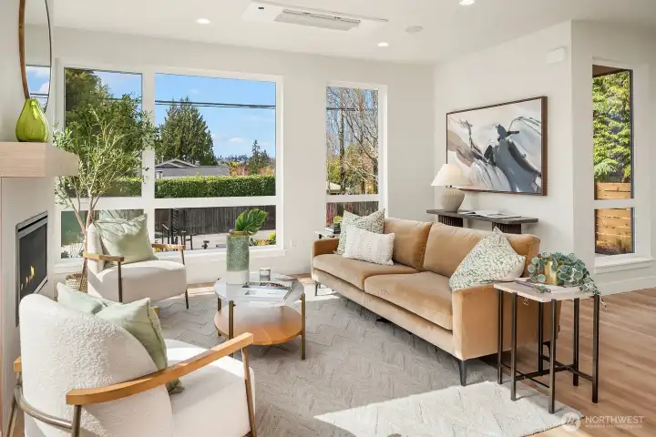 Floor to ceiling windows and sunny southwest exposure in the living room.