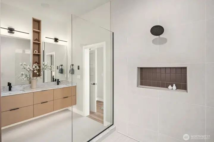 Floating vanity with thoughtful recessed shelving and deep-drawer storage. Note the additional lighting below the cabinets.
