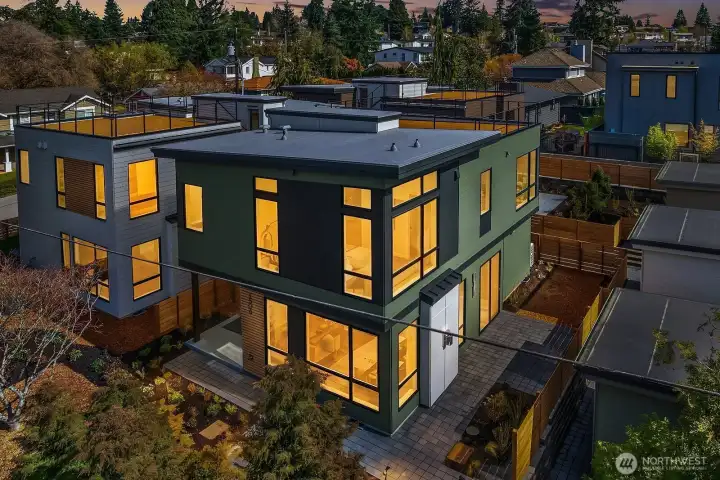 An overhead look at the precise architecture with tidy, fenced landscape and patio.