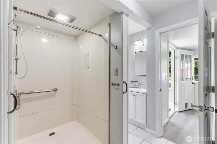 The bathroom features a walk-in shower with grab bars and a no-step entry for added ease of access.