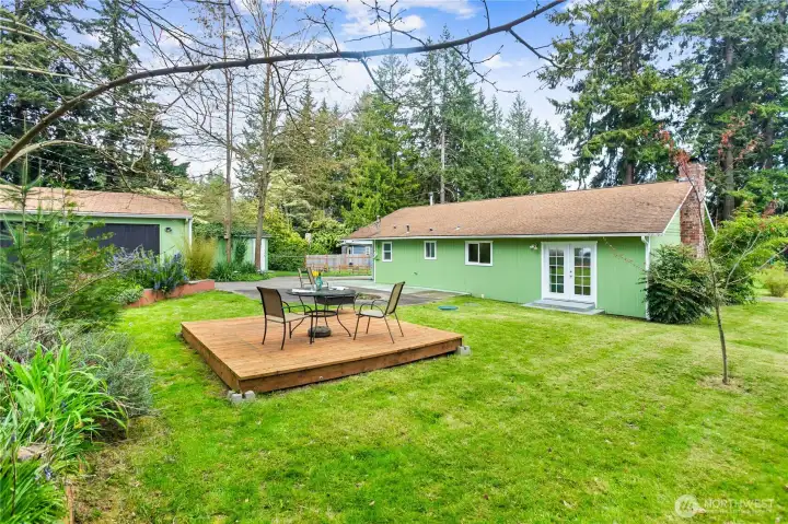 The backyard offers a peaceful setting to unwind on the freestanding deck while enjoying visiting wildlife.