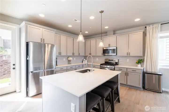 Extra Large Kitchen Island with stainless sink inlaid in beautiful quartz counter