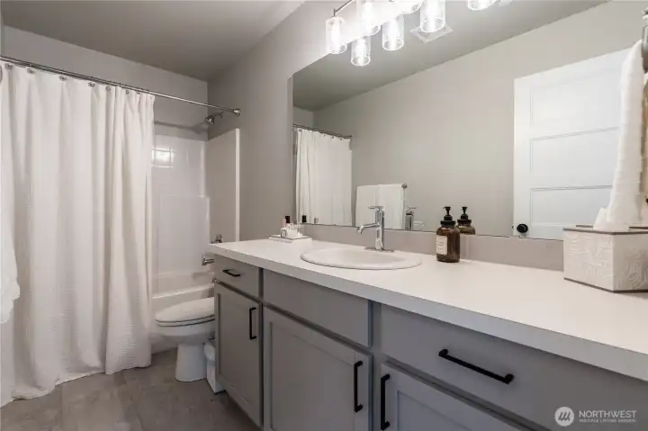 Double sink bathroom with bathtub shared by bedrooms on 3rd floor