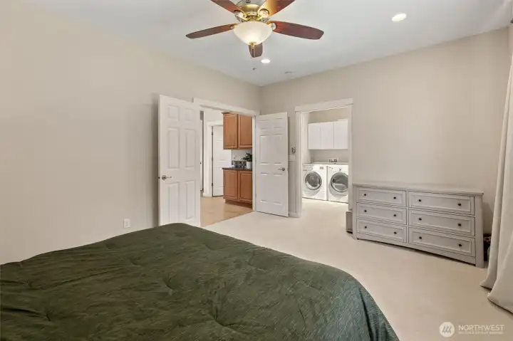 View looking out to the private laundry room and closet, and full bathroom. Perfect for multigenerational living!