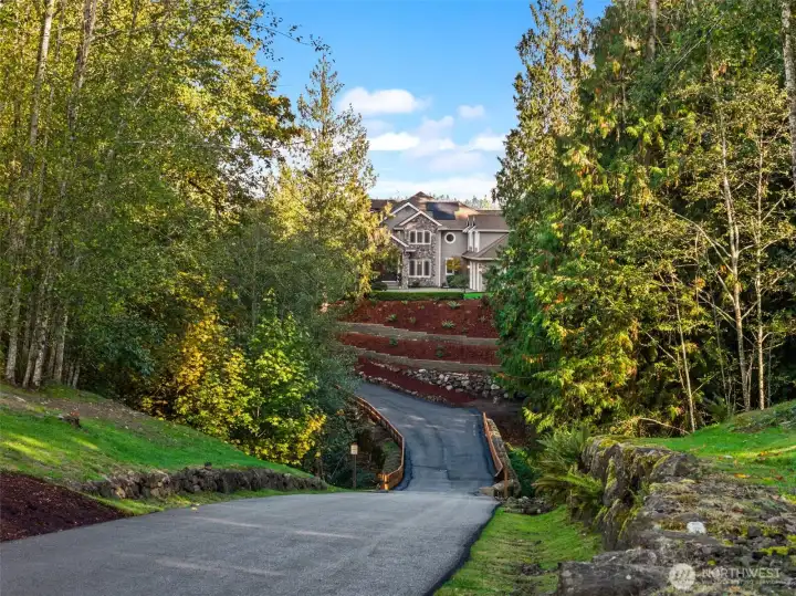A wide paved drive makes for a grand entrance. A wide paved drive makes for a grand entrance.