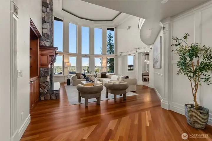 The grand entry continues into the great room with floor to ceiling windows allowing the outside, in. The grand entry continues into the great room with floor to ceiling windows allowing the outside, in.