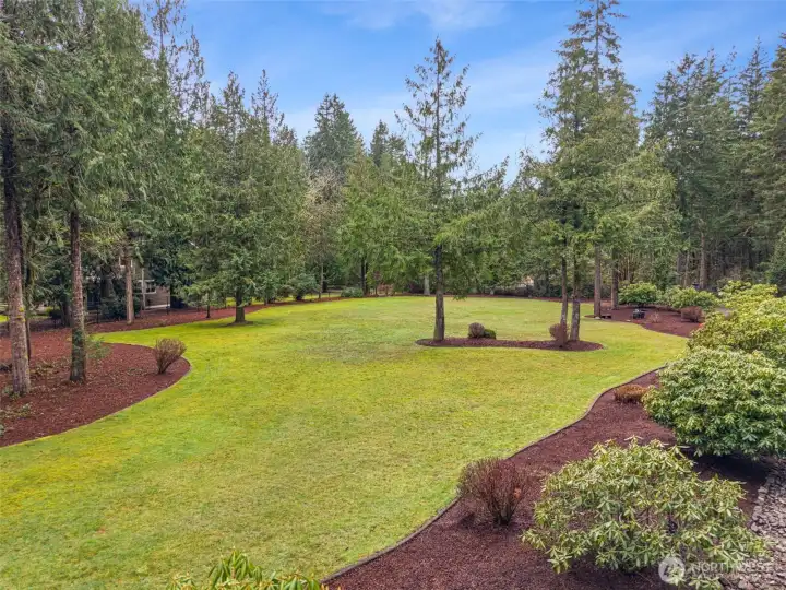 Shy acre of flat landscaped grounds on the property. Plans are available for a detached 3-car oversized garage with an RV space. Shy acre of flat landscaped grounds on the property. Plans are available for a detached 3-car oversized garage with an RV space.