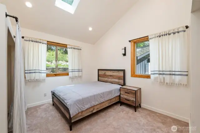 This bedroom is on the main floor, to the right of the kitchen. It is a new addition to the home, with big windows and high ceiling.