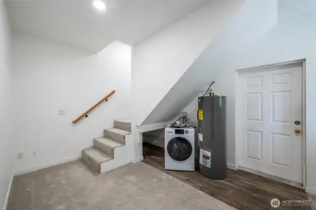 Laundry, storage and door to side porch at Hill House Garage/Shop. Up the stairs is an extra bedroom.