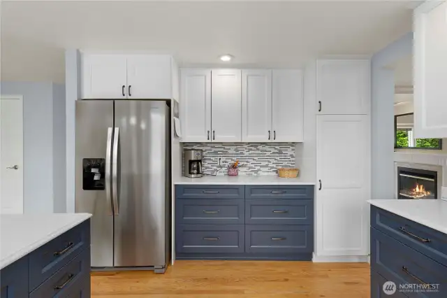 Beautiful blue cabinets on the lower level and white cabinets above.