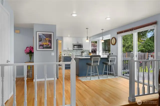 The kitchen offers a breakfast bar and room for a casual dining table.