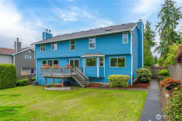 This view shows the back of the house and the yard.