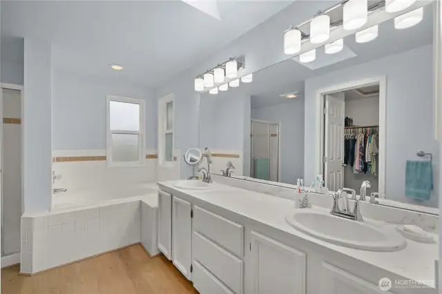 The primary suite 5 piece bath includes a separate tub and shower, double sinks and plenty of counterspace.
