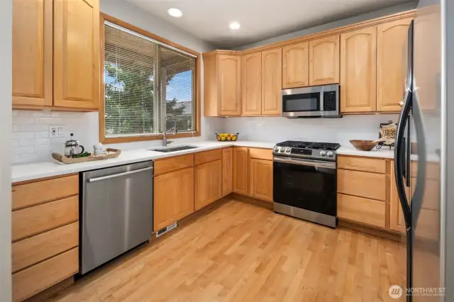 Newer counter top, Bosch dishwasher and stainless steel appliances.