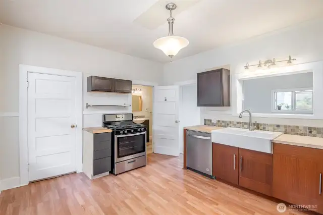 Kitchen with gas stove/range, updated flooring, appliances, and cabinets