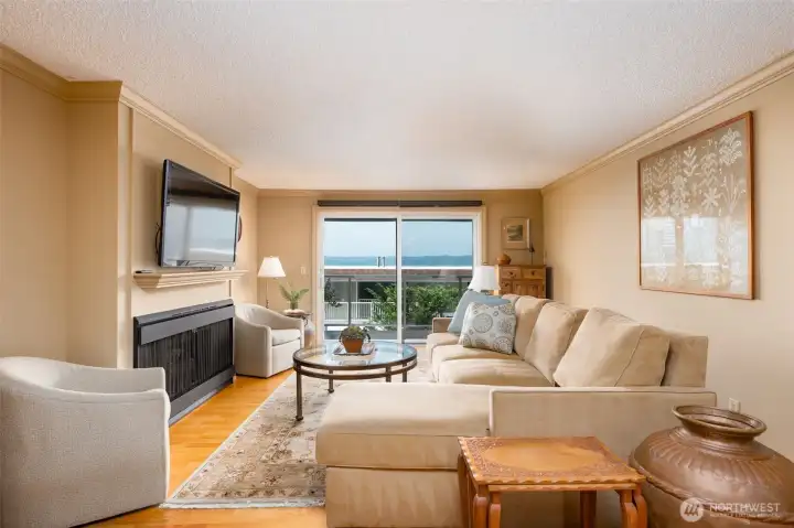 Sunny, welcoming living room with gas fireplace.