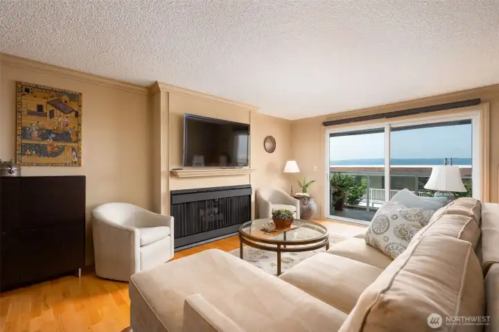 Pleasant and cheerful living room connects to the covered deck.