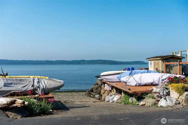 Boat launch, water toys are stored at the water's edge.