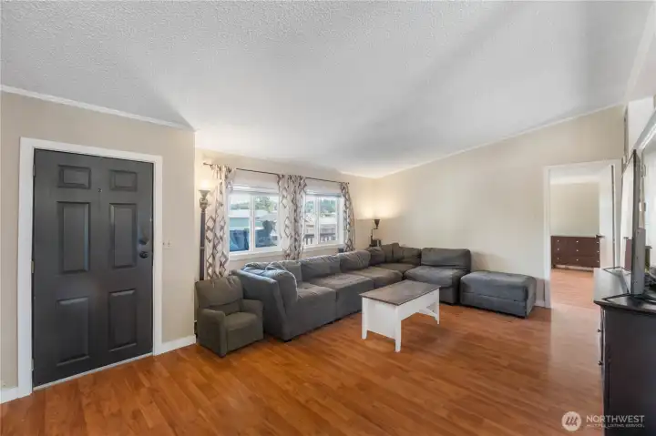 The view of the living room when entering from the rear porch.