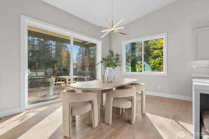 Dining area leads to covered outdoor living space with heat lamps for all-season enjoyment