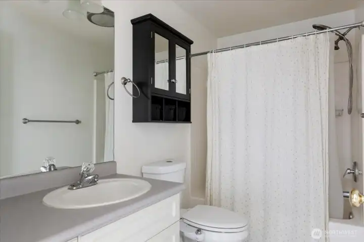 Guest bathroom conveniently located between the two bedrooms.
