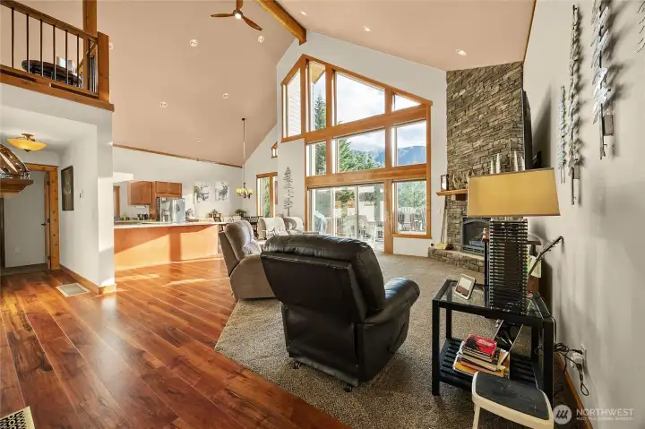 Breathtaking great room featuring soaring ceilings and panoramic forest & mountain views