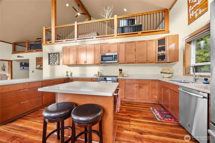 Open-concept kitchen offering a clear view of the loft above. Remote garage in far left upper cupboard. Fun!!!
