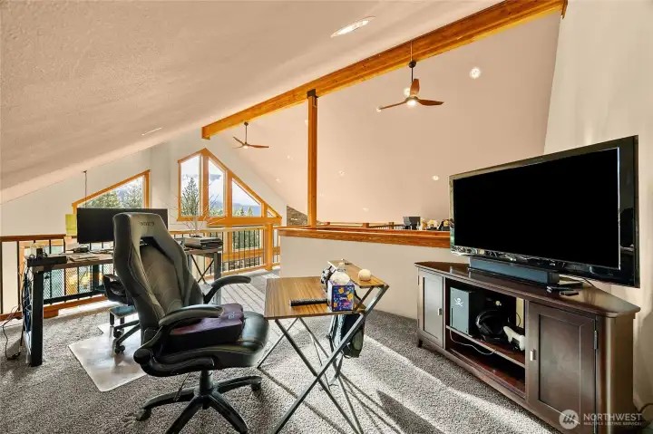 Expansive loft overlook highlighting the home's open architecture and soaring ceilings