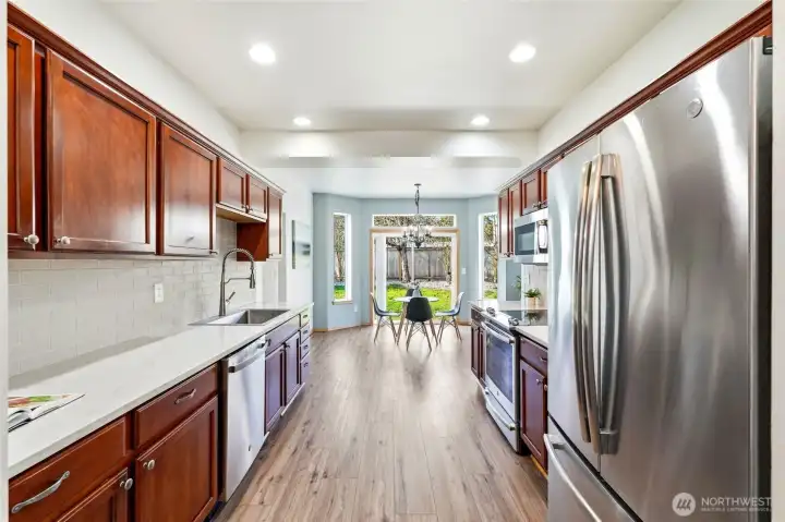 The updated kitchen showcases sleek new countertops and a stylish backsplash.