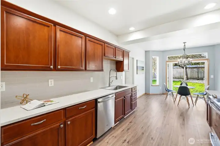 The layout opens seamlessly to the breakfast nook and family room for easy connection.