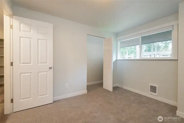 Same bedroom empty.  Bedroom 2 of 3.  There is a large closet just behind the door.  Ample room for a queen sized bed plus dresser and nightstands in this room.