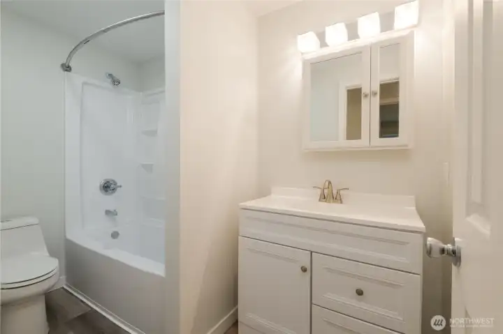 Bathroom 1 of 2.  Newly updated with cabinets and fixtures and flooring.