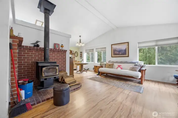 The wood stove heats this entire home and there is a ceiling fan in the kitchen to help circulate the warm air.