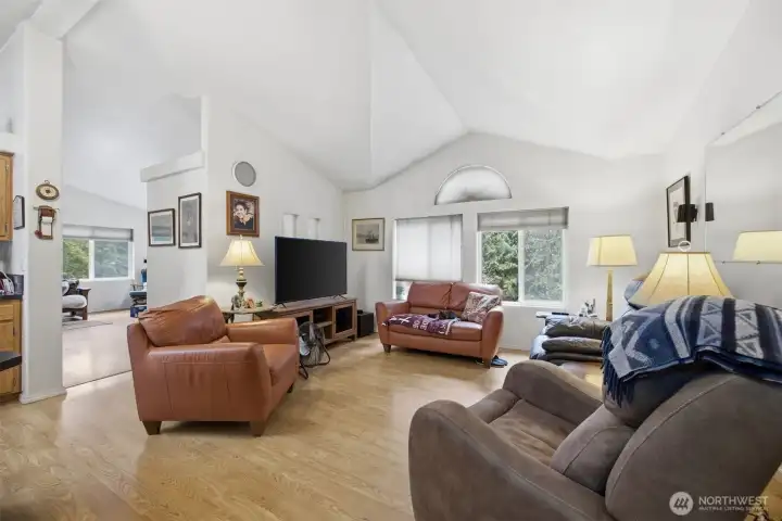 The family room is just beyond the freestanding wood stove that is in the living room.