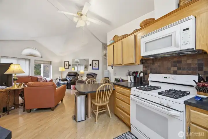 The kitchen is open to the family room and there is a 3 seat eating bar, gas range, dishwasher, and refrigerator that all stay with the sale of this home.
