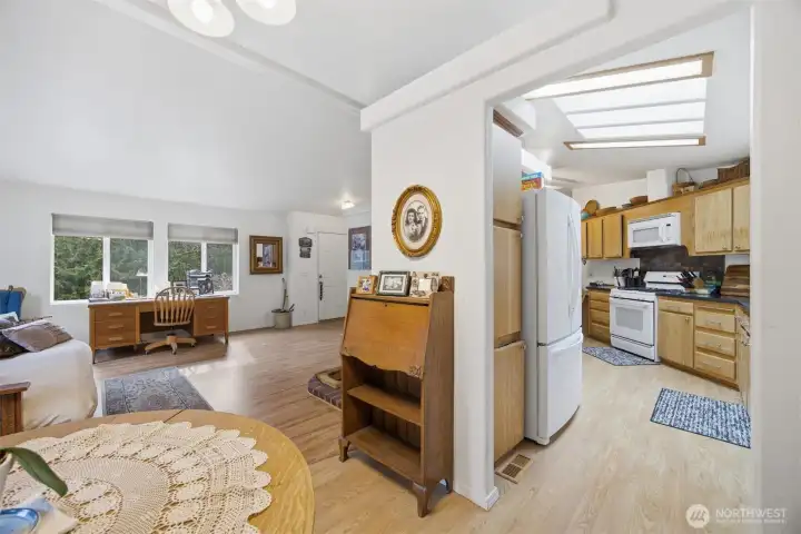 Looking from the dining room toward the front entry with the kitchen to the right.