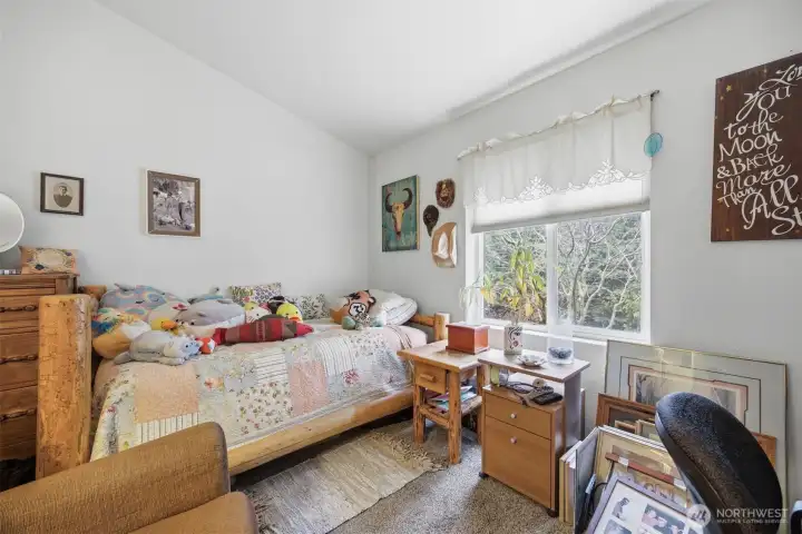 This is the guest bedroom and it is also fairly large with a regular wall closet.