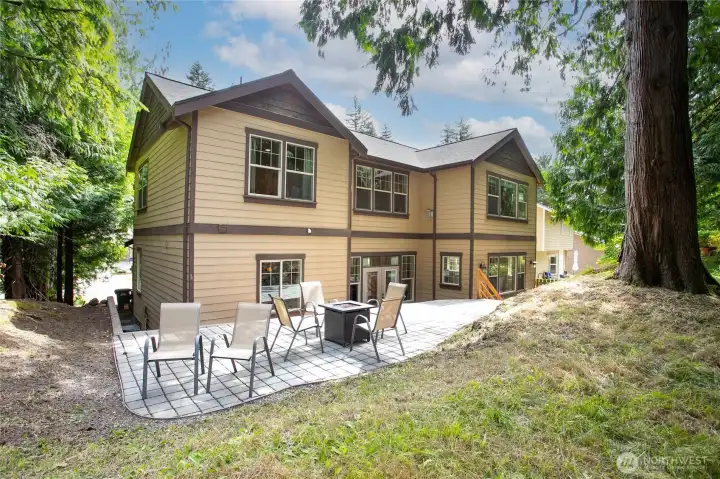 Back of house with elevated patio