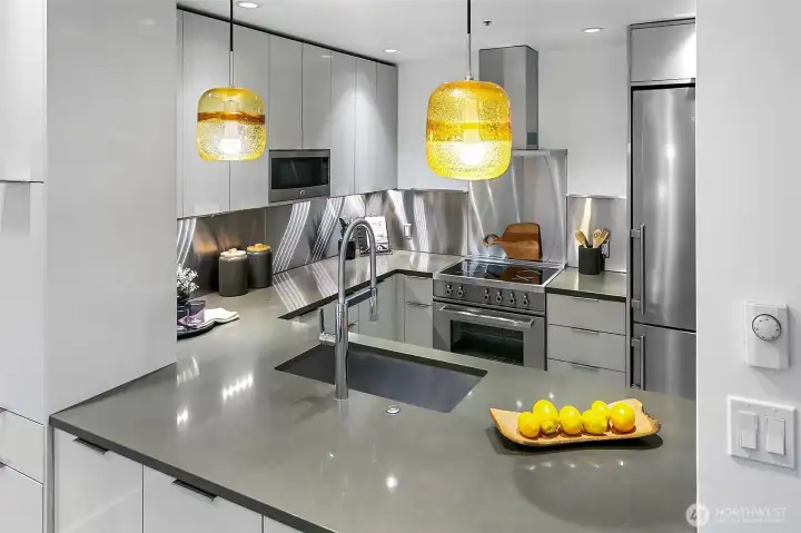 Beautifully updated kitchen is open to the dining area and features abundant storage.