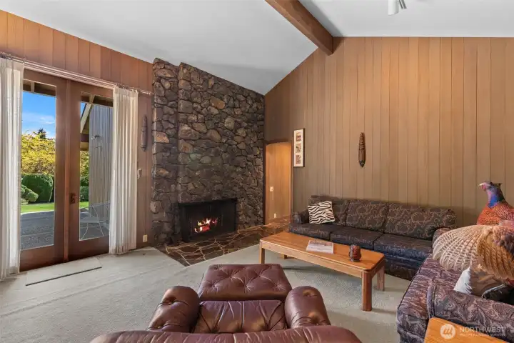 The warm inviting den has it's own fireplace and door to the private back patio.