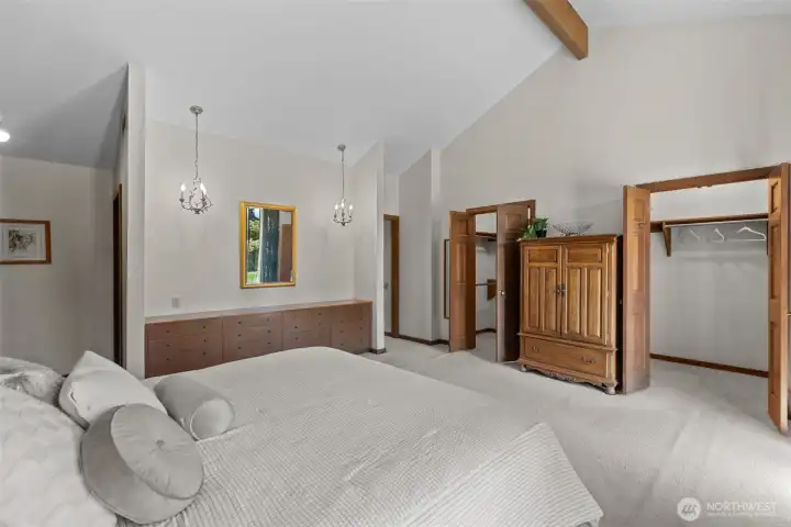 Private, Primary suite. two walk in closets, a peek toward the well appointed en suite bath.
