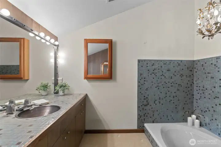Single vanity here with deep soaker tub